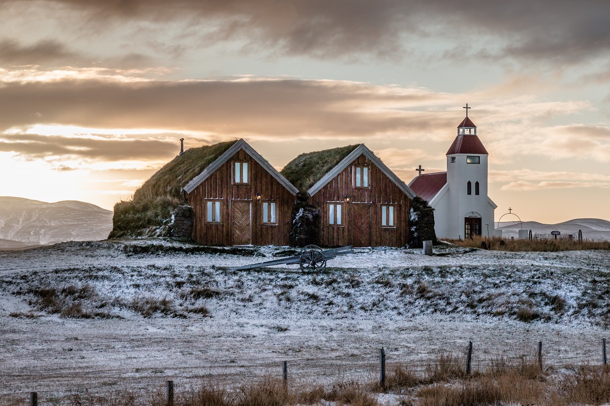 Turfhuisjes met grasdak en kerkje bij de accommodatie Modrudalur, in noordoost IJsland.