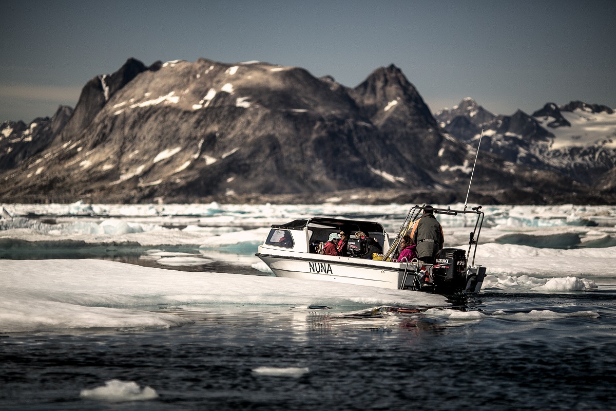 Boot vaart tussen de ijskappen in oost Groenland.